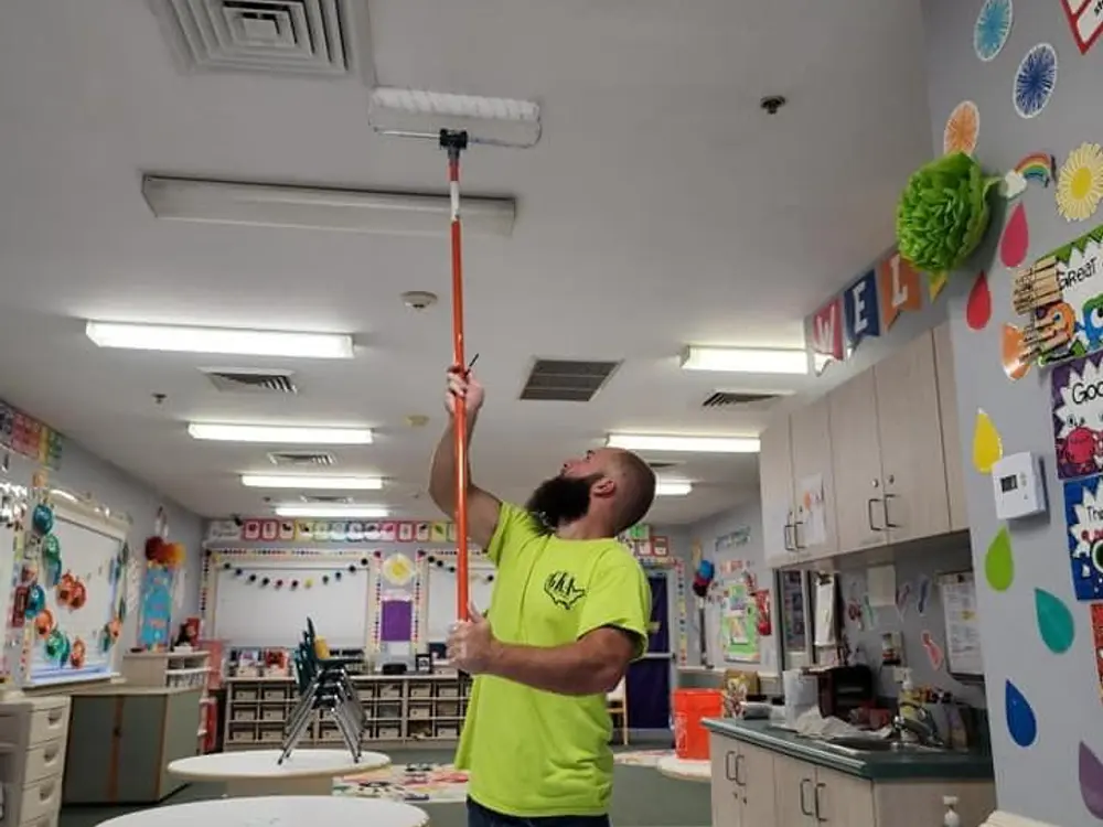 Painter working inside a commercial classroom