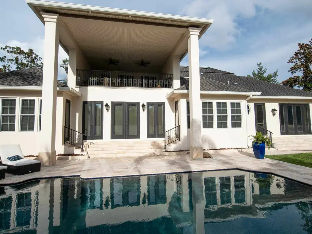 Residential exterior beside a screened pool
